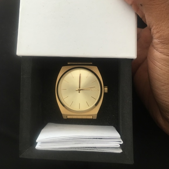 Gold Nixon time teller watch