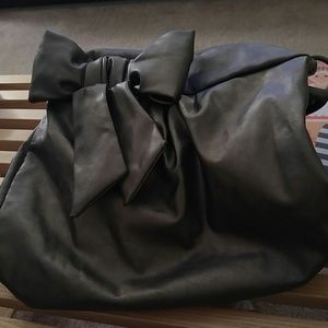 Silver bow Express purse with metal details.