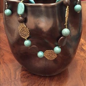 Turquoise stone necklace with matching earrings.