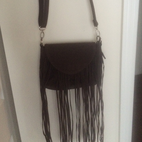A brown cross body fringe purse ,