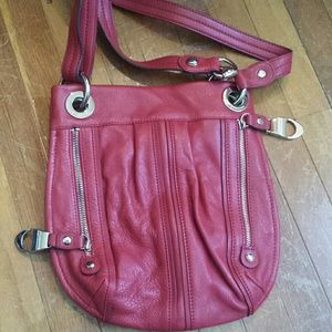 Red purse with zipper details.