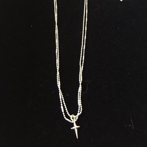 Silver chain necklace with a small cross