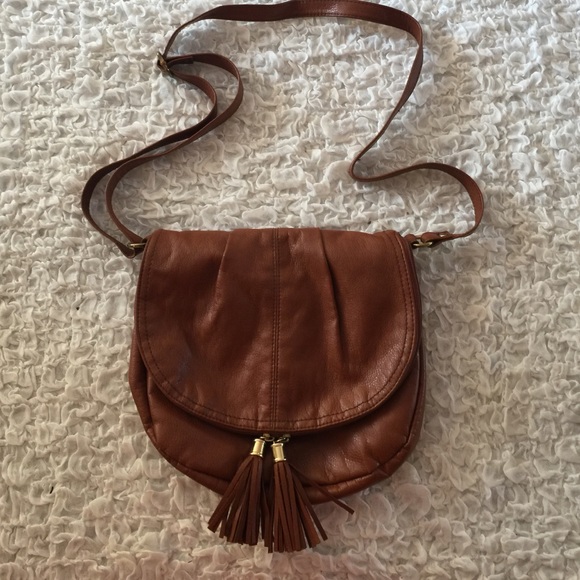 Brown cross body bag with tassel zipper.
