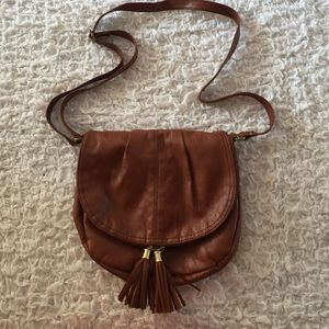Brown cross body bag with tassel zipper.