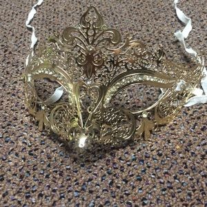 Gold masquerade mask with embellishments