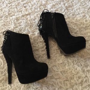 Black suede booties with laces on the heel