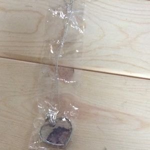 Silver necklace with purple flower in heart