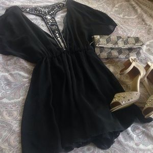 Stunning black romper with embellished back detail