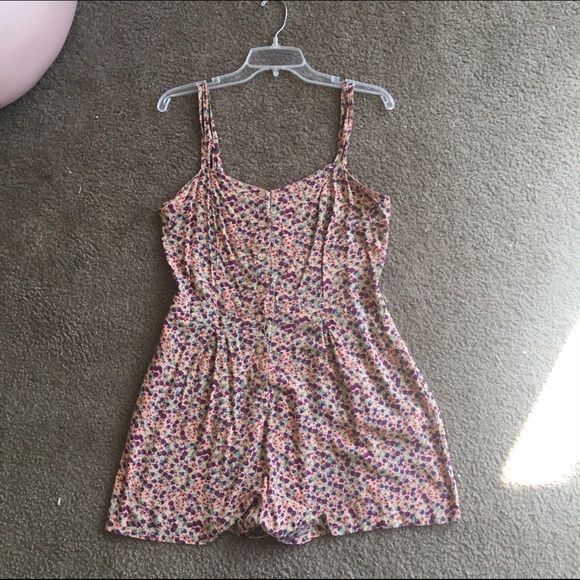 Tan button up romper with purple flower pattern