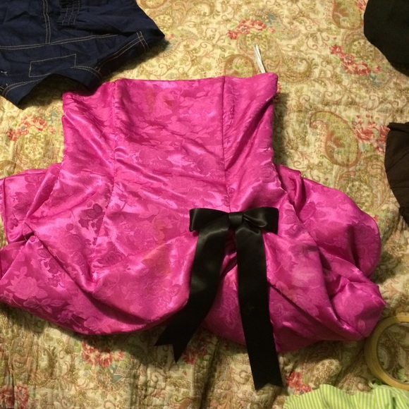 Pink dress with black bow and ruffles