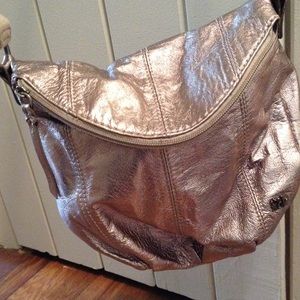 Metallic fold over cross-body purse.