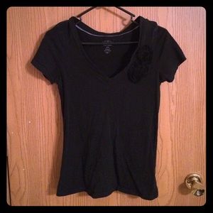 Black t shirt with flowers near sleeve