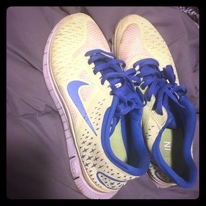 Green Nike free run running shoes with blue stripe