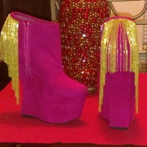 Pink wedge booties with gold chains.