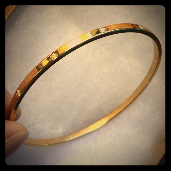 Thin yellow gold bangle bracelet with diamonds