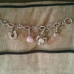 Juicy couture charm bracelet with four charms.