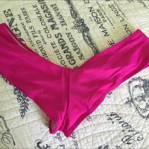 thong-like magenta swim bottoms