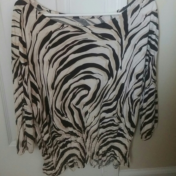Animal print blouse with gathered bottom.