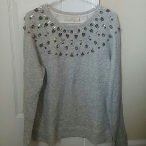 Long sleeve sweatshirt with jewels at the top.
