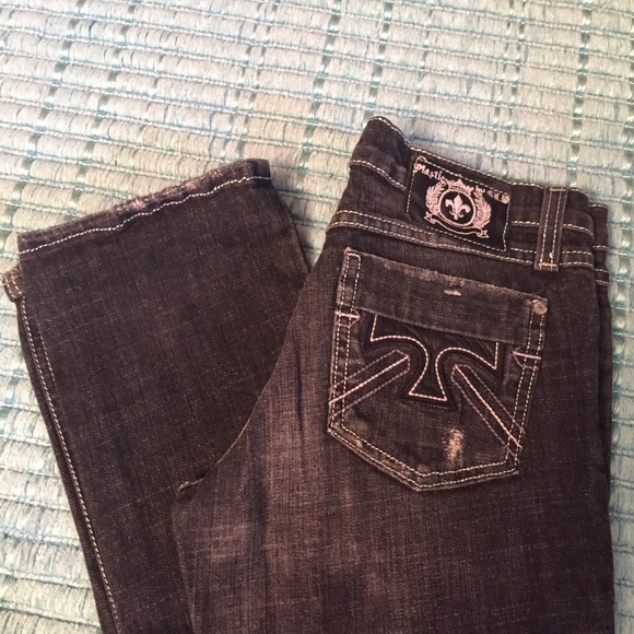 Dark grey jeans with detailing on back pockets.