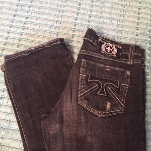 Dark grey jeans with detailing on back pockets.