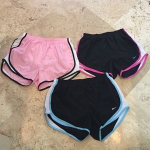 Three pairs of Nike Running Shorts.