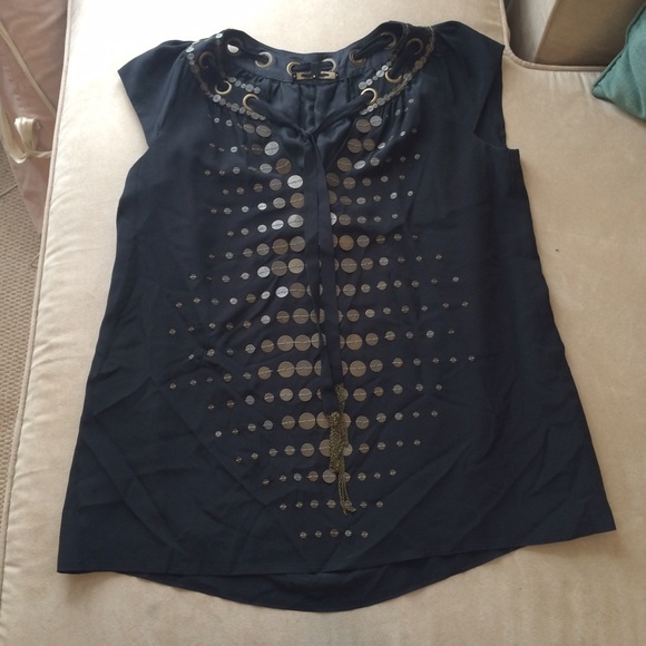 Black dress top with metal accents.