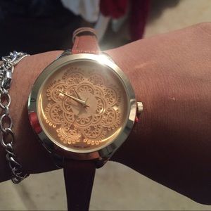 Gold mandala cutout dial watch.