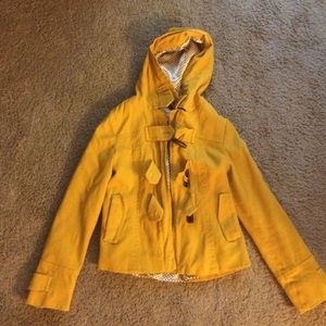 Hooded yellow zip up jacket with lining.