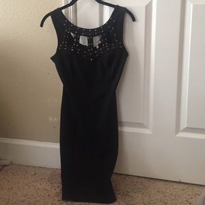 Black tight-fitting dress with gold studs
