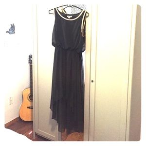 Black dress with gold trim around neck and arms.