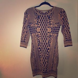 Metallic gold and black body conscious mini dress.