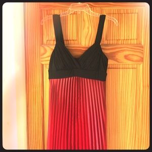 Floor length red and black gown with pleated skirt
