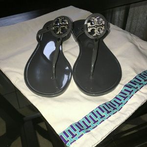 Tory Burch jellie slip on sandals in grey.