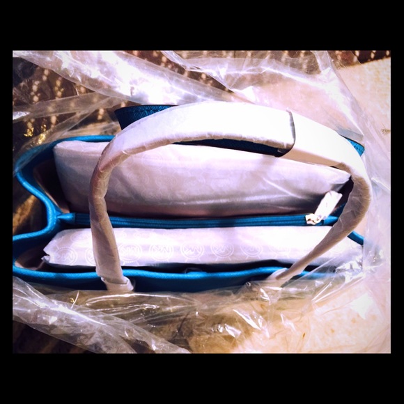 The inside of my teal Michael Kors bag
