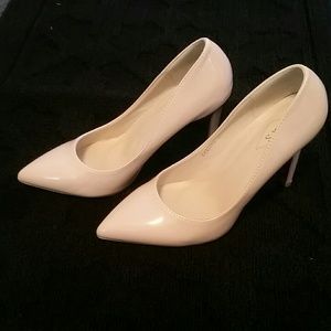 Nude patent pumps