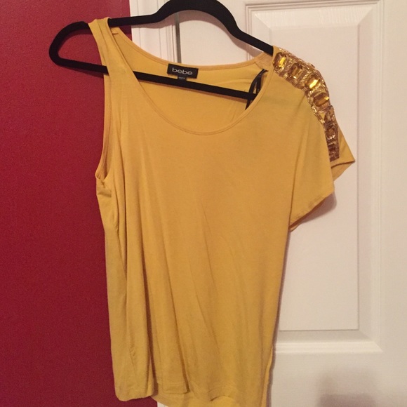Never worn Bebe top with embellished shoulder