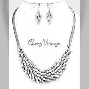 Burnished silver sculpted metal feathers necklace Burnished silver sculpted metal feathers necklace