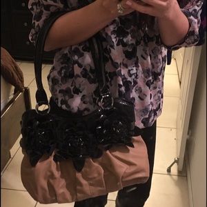 Brown purse with black flowers