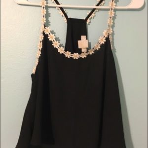 Black top with flower straps.