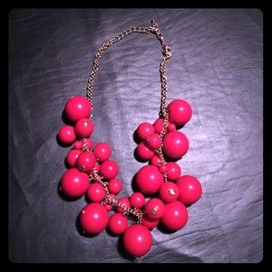 Red Necklace with gold chain.