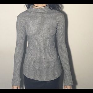 Gray turtleneck with flared sleeves