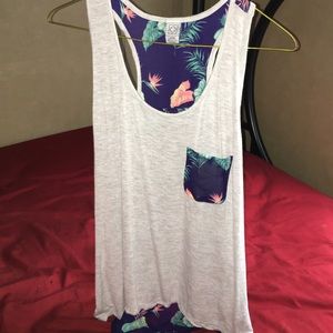 sleeveless shirt w/ flowers.