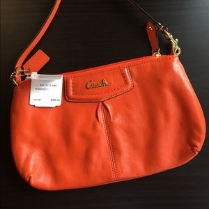 Orange Coach leather wristlet