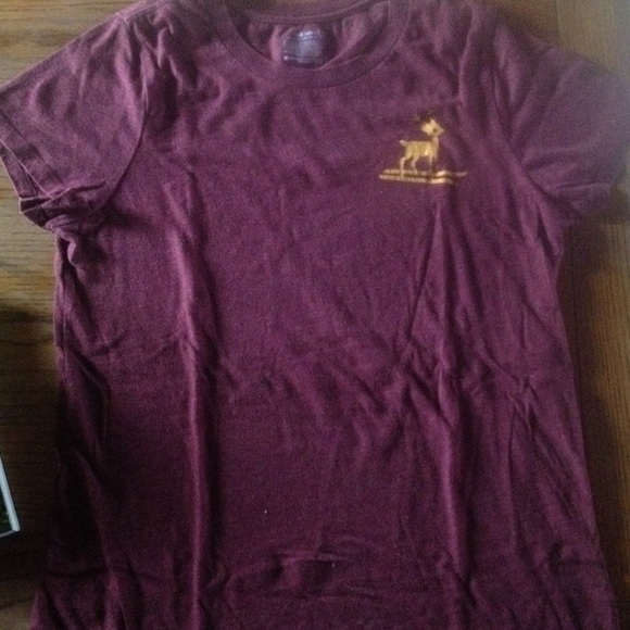 Maroon round neck t-shirt with gold deer.