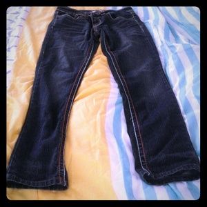 Dark wash faded blue jeans.