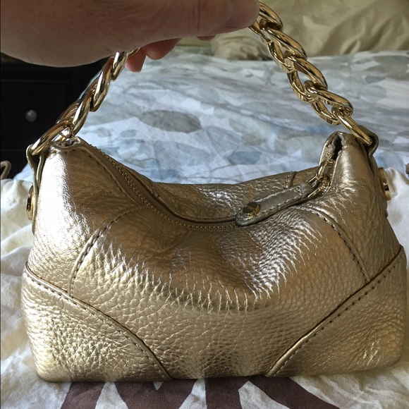 Michael Kors gold leather handbag.