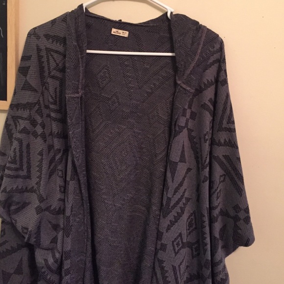 Gray and black poncho .