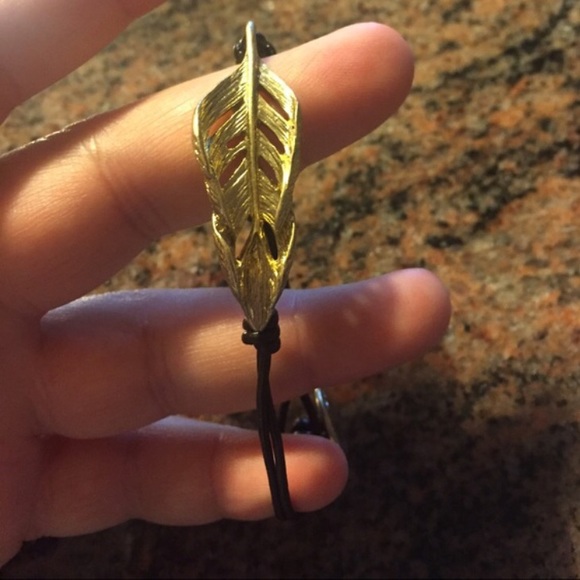 Gold feather bracket with leather band