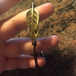 Gold feather bracket with leather band